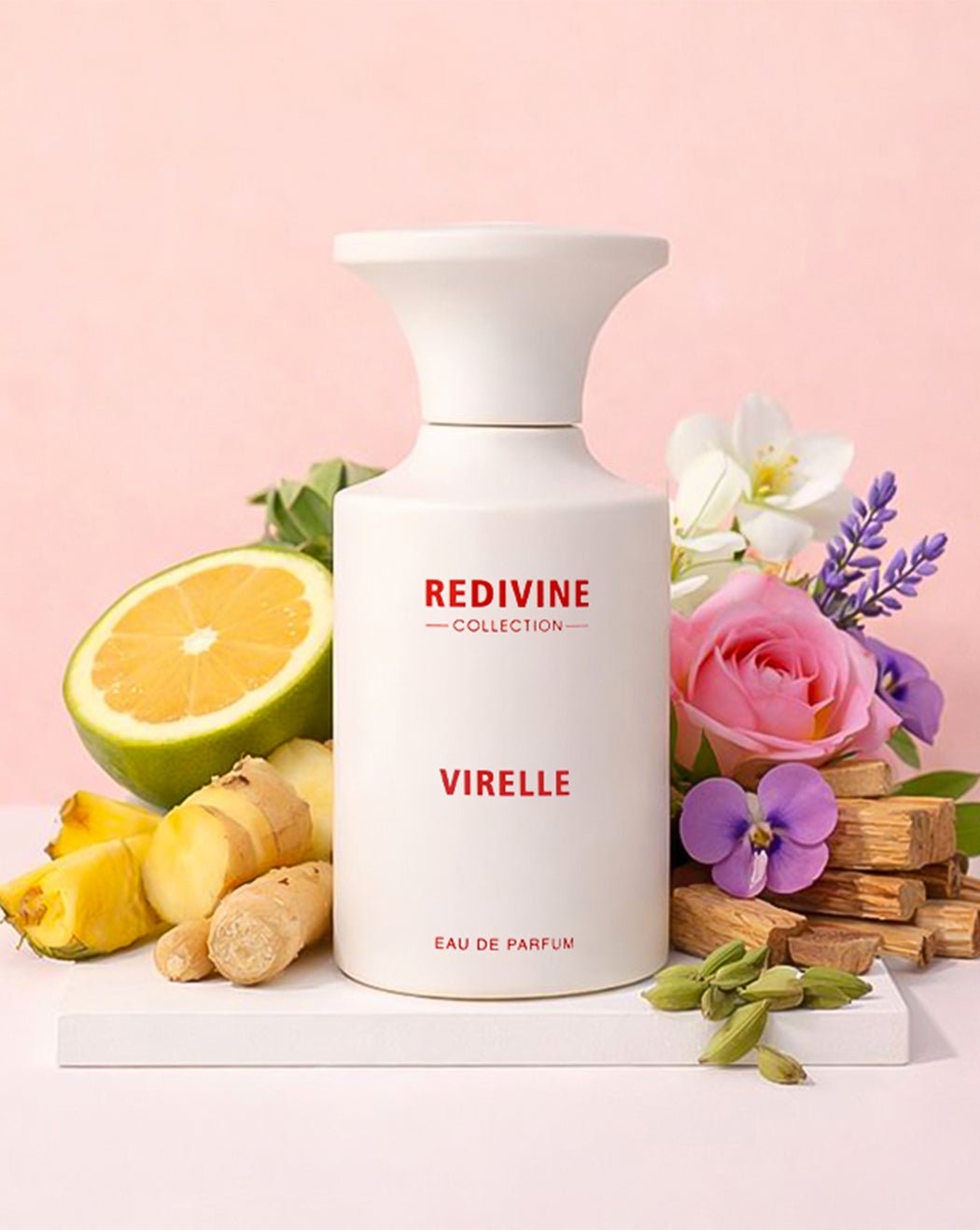 White perfume bottle labeled 'Virelle' from the 'Redivine Collection' with flowers and fruits on a pink background.